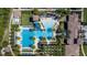 Aerial shot of a beautiful community pool, featuring palm trees, slides, and comfortable lounge seating at 28355 Picana, Wesley Chapel, FL 33543
