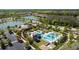 Aerial view showcasing a community pool area, including palm trees, water slide, and clubhouse at 28355 Picana, Wesley Chapel, FL 33543