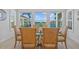 Dining area features a table for six, and stunning views of the backyard, pool, and lake at 28355 Picana, Wesley Chapel, FL 33543
