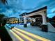 A luxurious house with a beautiful pool and outdoor seating area is showcased at twilight at 28355 Picana, Wesley Chapel, FL 33543