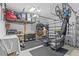 Well-organized garage with storage shelves, work bench, and sports equipment rack offers space for hobbies at 28355 Picana, Wesley Chapel, FL 33543