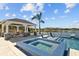 Charming gazebo with comfortable seating overlooks a sparkling pool and serene lake at 28355 Picana, Wesley Chapel, FL 33543