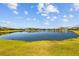 Expansive lake view surrounded by lush green lawns and distant homes, creating a peaceful vista at 28355 Picana, Wesley Chapel, FL 33543