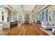 Expansive living room with high ceilings, elegant chandelier, stone fireplace, and hardwood floors at 28355 Picana, Wesley Chapel, FL 33543