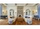 Elegant lounge with stylish seating, stone fireplace, and arched doorways, creating a warm and inviting atmosphere at 28355 Picana, Wesley Chapel, FL 33543