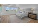 Spacious main bedroom featuring hardwood floors, three windows, and modern furnishings at 28355 Picana, Wesley Chapel, FL 33543