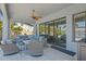 Relaxing outdoor living space with a comfortable sectional sofa and ceiling fan at 28355 Picana, Wesley Chapel, FL 33543