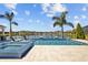 Beautiful backyard featuring a sparkling pool, integrated spa, and scenic lake views at 28355 Picana, Wesley Chapel, FL 33543