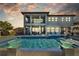 Luxury home's outdoor space featuring a large pool, spa, covered patio, and lounge seating at 28355 Picana, Wesley Chapel, FL 33543