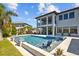 Inviting pool and spa area with built-in seating and views of the spacious backyard and home at 28355 Picana, Wesley Chapel, FL 33543