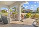 Inviting covered porch with comfortable seating, views of the lush front yard and neighborhood at 28355 Picana, Wesley Chapel, FL 33543
