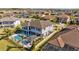Gorgeous backyard featuring a large pool, outdoor kitchen, covered patio, and well-maintained landscaping at 28355 Picana, Wesley Chapel, FL 33543