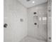 Modern shower featuring marble tiling, dual shower heads, and built-in shelving at 28355 Picana, Wesley Chapel, FL 33543