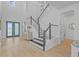 Elegant staircase with dark wood and white railings leads to the upper level of the home at 28355 Picana, Wesley Chapel, FL 33543
