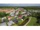 Aerial view of homes in a neighborhood with a golf course and a community shopping center at 29250 Princeville Dr, San Antonio, FL 33576