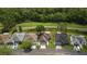 An aerial view of homes with well-manicured lawns and a golf course in the background at 29250 Princeville Dr, San Antonio, FL 33576