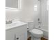 Bright bathroom featuring white tile, a toilet, and a vanity sink with modern fixtures at 29250 Princeville Dr, San Antonio, FL 33576