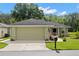 View of the home's exterior showcasing its neutral stucco, attached garage, and driveway at 29250 Princeville Dr, San Antonio, FL 33576