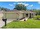 Charming home with a well-manicured lawn, beautiful landscaping, and a two-car garage at 29250 Princeville Dr, San Antonio, FL 33576