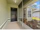 Welcoming front porch with black door and charming landscaping enhances curb appeal at 29250 Princeville Dr, San Antonio, FL 33576
