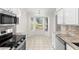 Bright kitchen with stainless steel appliances, granite countertops, and a bay window breakfast nook at 29250 Princeville Dr, San Antonio, FL 33576