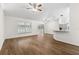 Open-concept living space featuring modern flooring, bright lighting, and a peninsula at 29250 Princeville Dr, San Antonio, FL 33576