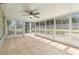 A sunroom with tile flooring and lots of windows at 29250 Princeville Dr, San Antonio, FL 33576