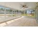 A sunroom with tile flooring and lots of windows at 29250 Princeville Dr, San Antonio, FL 33576