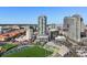 Wide aerial view of a modern high rise near an athletic field, set against the city skyline at 301 1St S St # 2205, St Petersburg, FL 33701