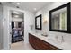 Bright bathroom with dual sink vanity, decorative mirrors and access to walk-in closet at 301 1St S St # 2205, St Petersburg, FL 33701