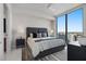 Comfortable bedroom features a large window with a city view and stylish decor at 301 1St S St # 2205, St Petersburg, FL 33701