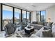 Open-concept living room boasts floor-to-ceiling windows with city views and comfortable seating at 301 1St S St # 2205, St Petersburg, FL 33701