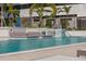 Inviting pool area featuring submerged lounge seating, cabanas, and lush tropical landscape at 301 1St S St # 2205, St Petersburg, FL 33701