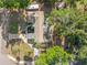 Aerial view of a property showcasing its roof, driveway, and mature trees on a sunny day at 320 Lake Maggiore S Blvd, St Petersburg, FL 33705