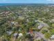 Aerial view of a home in a lush, green neighborhood with a distant ocean view at 320 Lake Maggiore S Blvd, St Petersburg, FL 33705