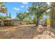 A spacious backyard featuring a shed, a boat, and lush trees at 320 Lake Maggiore S Blvd, St Petersburg, FL 33705
