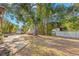 Large backyard with mature trees, a storage shed, and space for outdoor activities at 320 Lake Maggiore S Blvd, St Petersburg, FL 33705