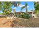Spacious backyard with a patio, lush landscaping, mature trees and enclosed porch at 320 Lake Maggiore S Blvd, St Petersburg, FL 33705