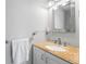 Bathroom with a white vanity and a gold speckled countertop, complemented by a silver framed mirror at 320 Lake Maggiore S Blvd, St Petersburg, FL 33705