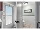 View of bathroom with white tiled walls, black accents, and a modern toilet, seen through an open door at 320 Lake Maggiore S Blvd, St Petersburg, FL 33705