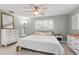 Bright bedroom with a ceiling fan, clean white bedding, shuttered window and neutral decor at 320 Lake Maggiore S Blvd, St Petersburg, FL 33705