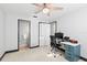 Bright bedroom with a ceiling fan, adjacent bathroom, neutral decor, and a desk at 320 Lake Maggiore S Blvd, St Petersburg, FL 33705