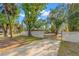Spacious driveway behind a gate leading to the property, surrounded by mature trees at 320 Lake Maggiore S Blvd, St Petersburg, FL 33705