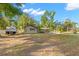 Home with neutral paint, mature trees, trailer parked in driveway, carport and long driveway at 320 Lake Maggiore S Blvd, St Petersburg, FL 33705