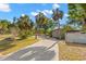 Beautiful home with palm trees and long driveway, highlighting curb appeal on a sunny day at 320 Lake Maggiore S Blvd, St Petersburg, FL 33705
