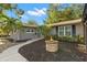 Charming single-story home with a cozy front yard featuring a stone fire pit and mature landscaping at 320 Lake Maggiore S Blvd, St Petersburg, FL 33705