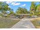 Charming home with a well-maintained lawn, mature trees, covered parking and updated landscaping at 320 Lake Maggiore S Blvd, St Petersburg, FL 33705