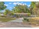 Charming home with a well-maintained lawn, mature trees, covered parking and updated landscaping at 320 Lake Maggiore S Blvd, St Petersburg, FL 33705