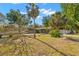 Charming single-story home with a lush front yard featuring mature trees and vibrant landscaping on a sunny day at 320 Lake Maggiore S Blvd, St Petersburg, FL 33705