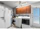 Laundry room featuring modern washer and dryer, with cabinets and storage, creating a functional space at 320 Lake Maggiore S Blvd, St Petersburg, FL 33705